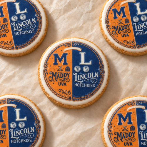Orange-and-navy cookies personalized for Maddy and Lincoln, arranged on cream parchment.