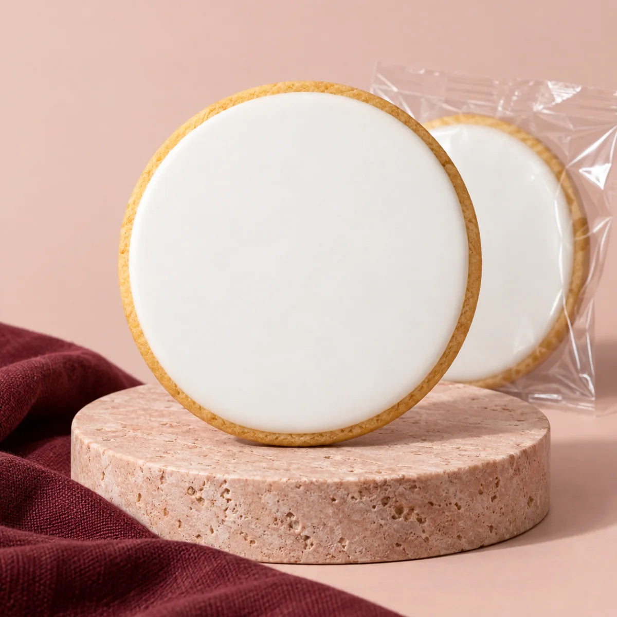 A vanilla cookie on a blush display with an individually packaged cookie behind it