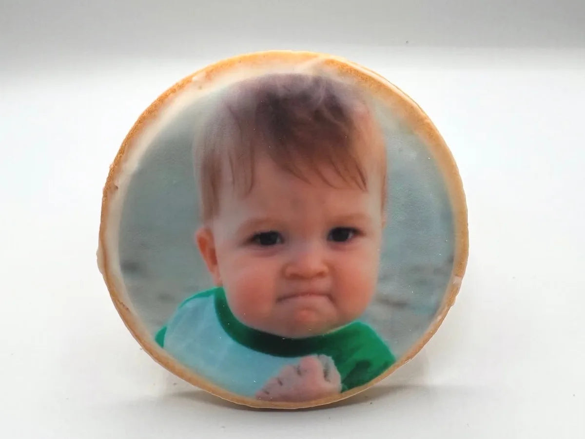 A baby portrait printed on a round iced cookie
